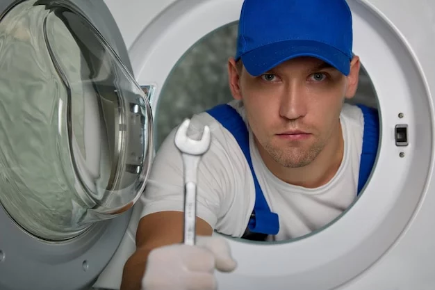 A technician working on a washing machine repair