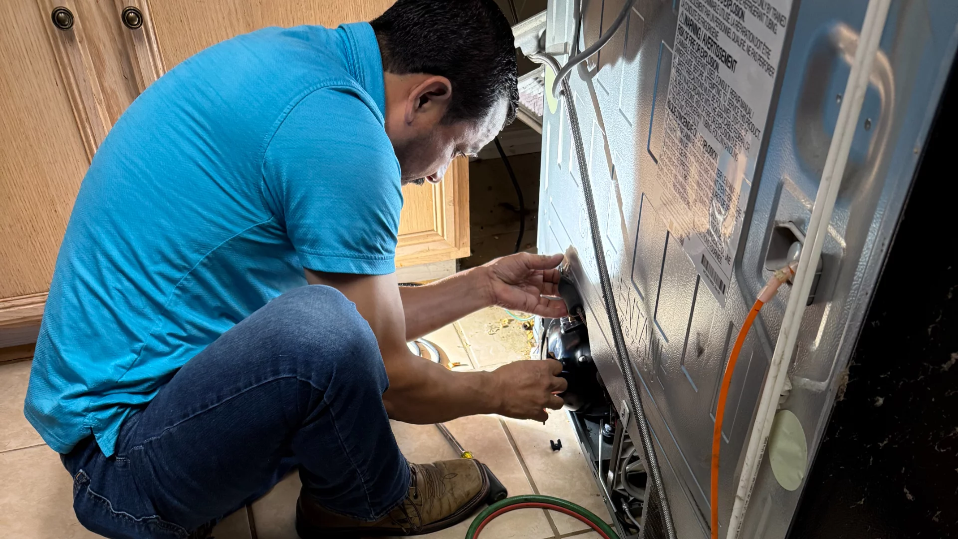 Repairing a refrigerator in a modern kitchen