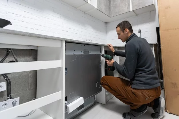 Repairing a refrigerator in a modern kitchen